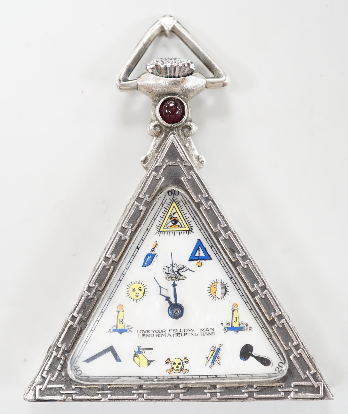 A 1920's Swiss 800 standard white metal triangular masonic pocket watch, by the Solvil Watch Co. set with cabochon garnet, the mother of pearl dial decorated with masonic symbols, width, 51mm.